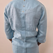 Sky blue linen two-piece set featuring a V-neck tunic with three-quarter sleeves and matching relaxed-fit trousers. - Back View