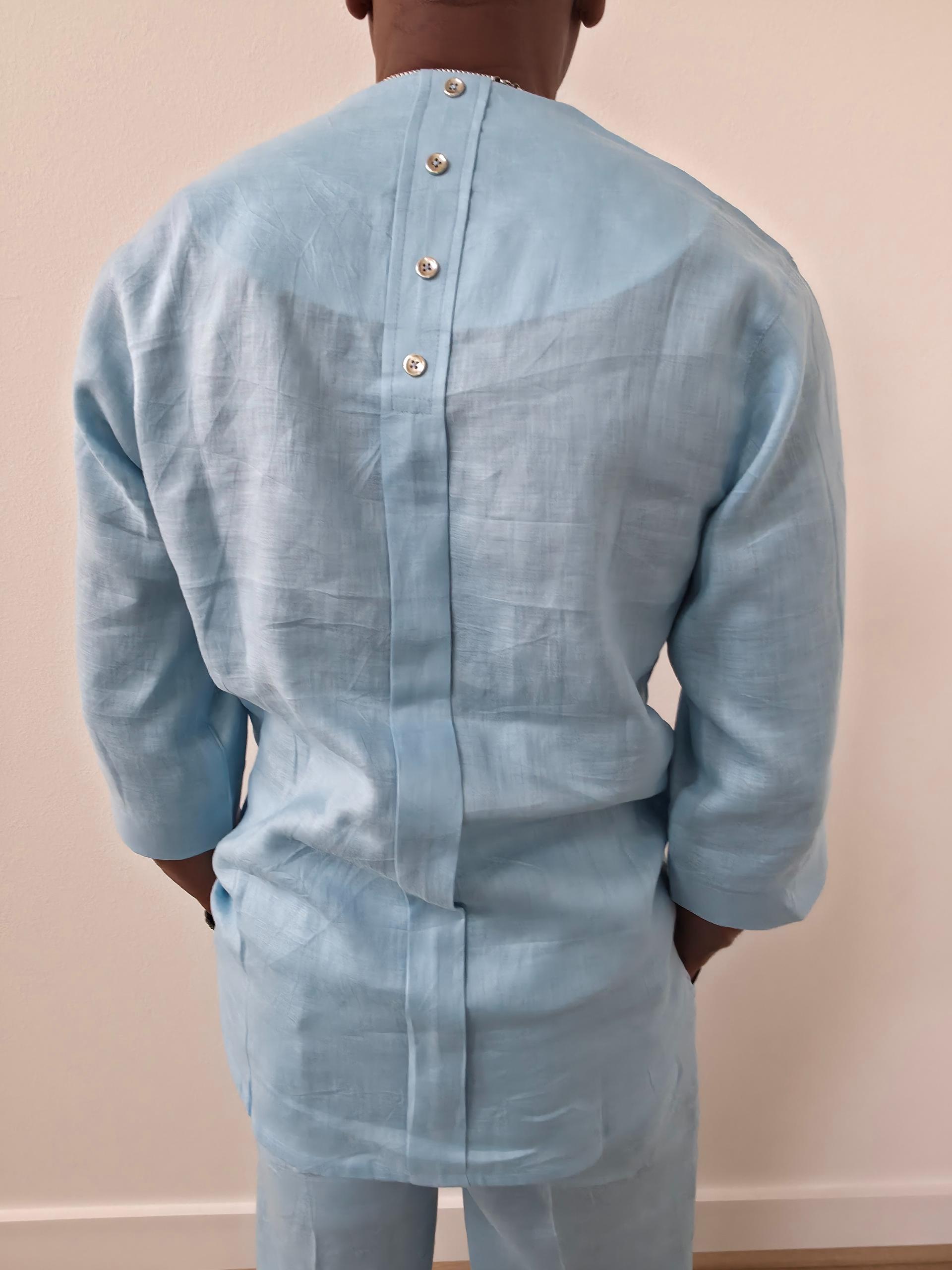 Sky blue linen two-piece set featuring a V-neck tunic with three-quarter sleeves and matching relaxed-fit trousers. - Back View