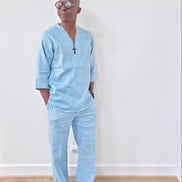 Sky blue linen two-piece set featuring a V-neck tunic with three-quarter sleeves and matching relaxed-fit trousers. -Leaning