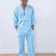 Sky blue linen two-piece set featuring a V-neck tunic with three-quarter sleeves and matching relaxed-fit trousers. -Front View