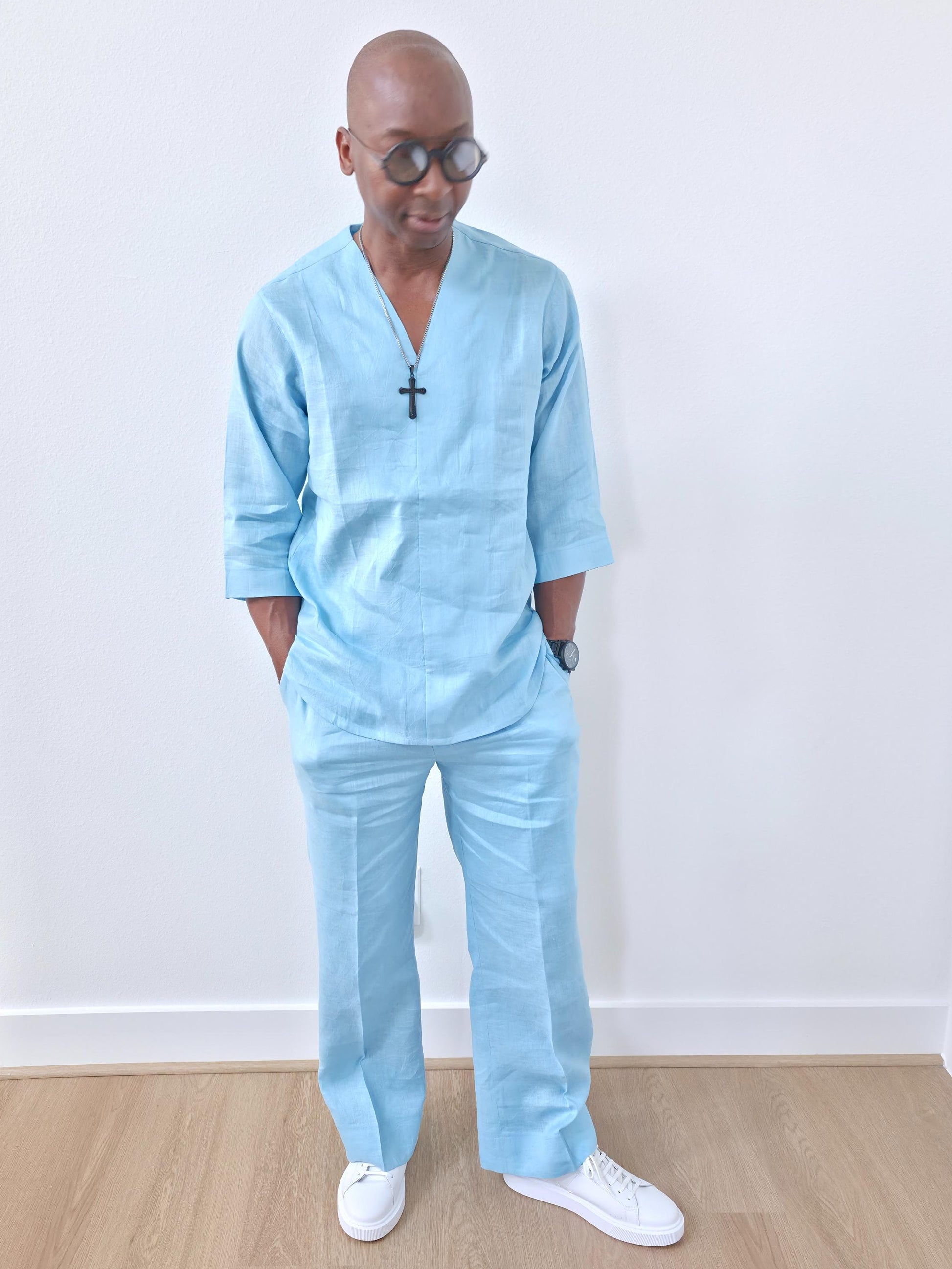 Sky blue linen two-piece set featuring a V-neck tunic with three-quarter sleeves and matching relaxed-fit trousers. -Front View