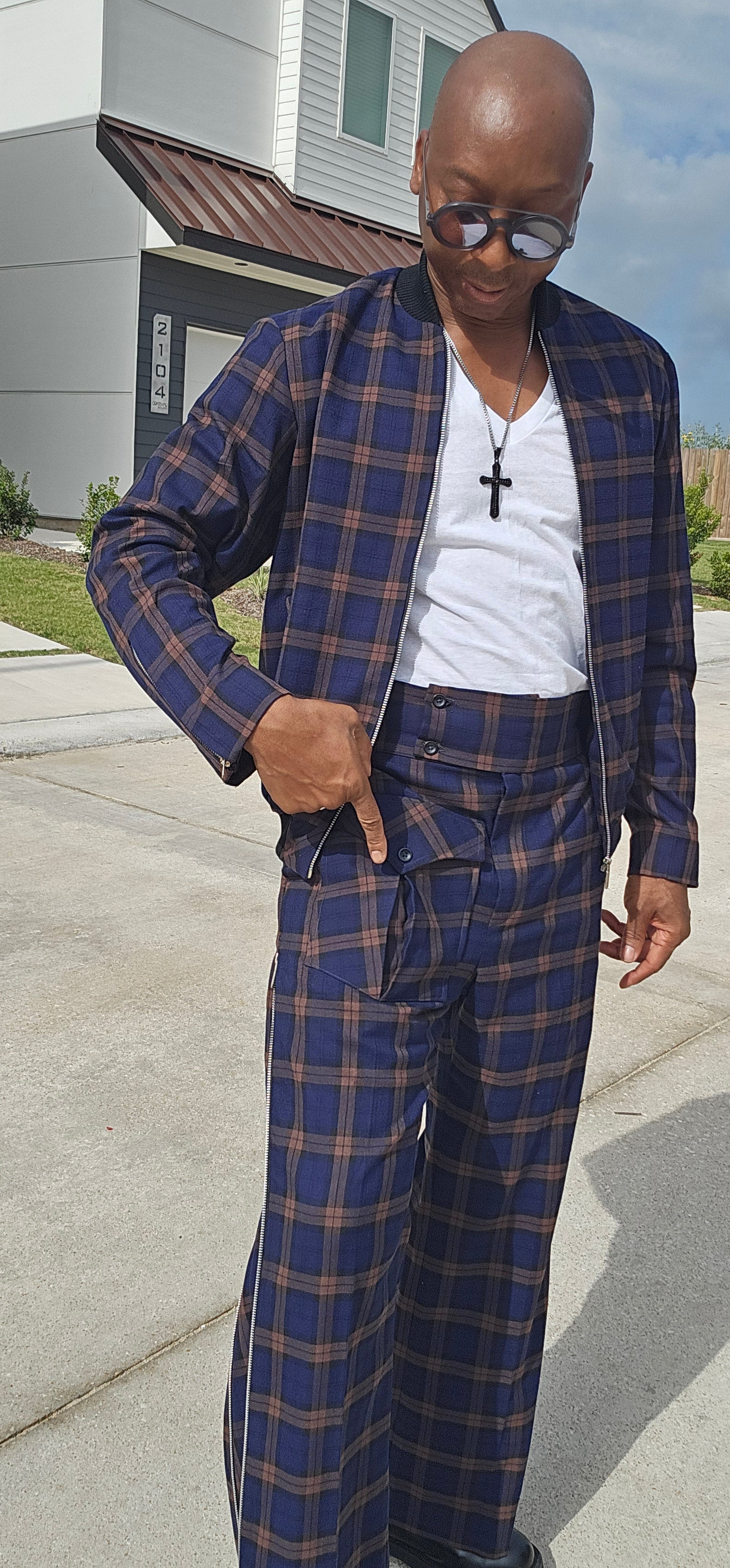 Two-Piece Tracksuit featuring a navy and rust plaid bomber jacket and matching high-waisted wide-leg trousers with side seam zippers.