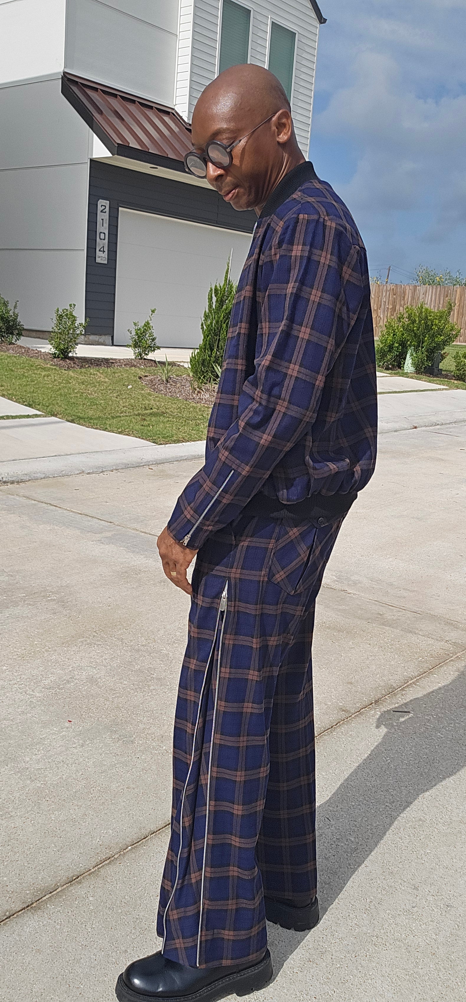 Two-Piece Tracksuit featuring a navy and rust plaid bomber jacket and matching high-waisted wide-leg trousers with side seam zippers.