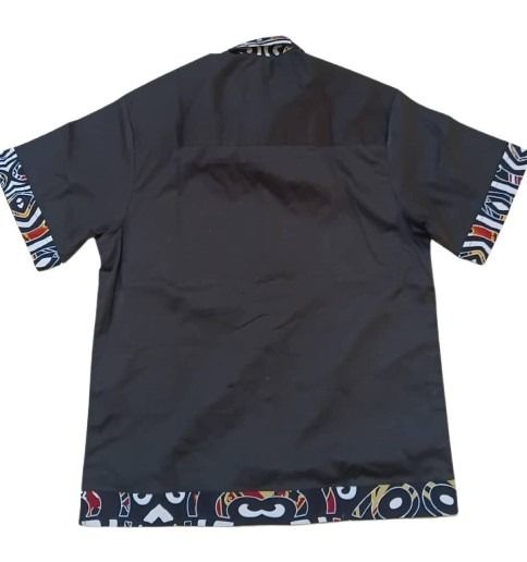 Black shirt with colorful patterned sleeves on a white background