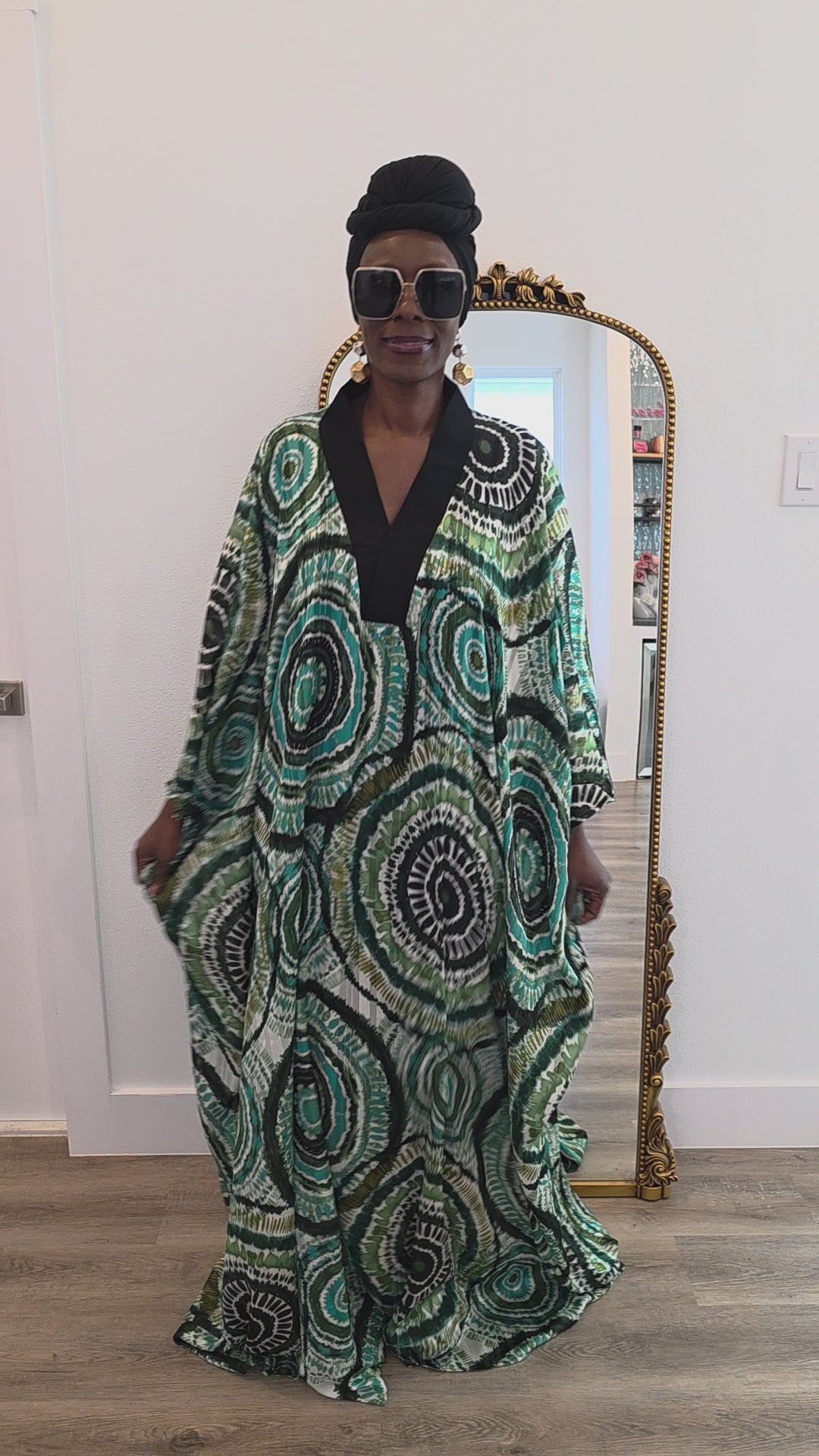 Patterned Boubou Kaftan featuring a green and black concentric circular print, a solid black V-neckline, and a wide-wing silhouette.